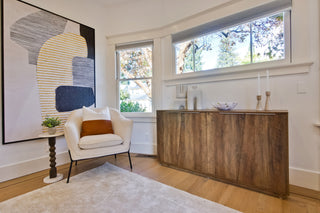 Modern living room with beige sofa, coffee table, and decorative elements.