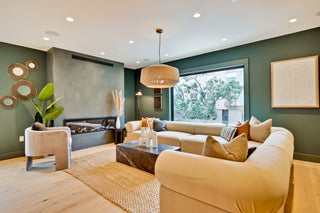 Modern living room with a beige sofa, coffee table, and decorative elements.