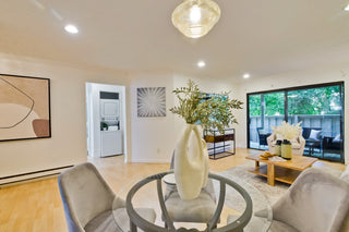 Modern living room with a vase of flowers, coffee table, and decorative items.