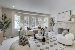 Modern living room with gray sofa, beige armchair, and woodens coffee table.