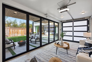 Modern living room with large glass doors leading to a patio area.