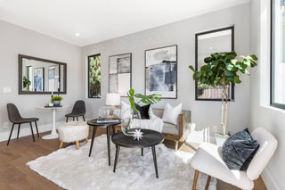 Modern living room with white walls, furniture, and decor