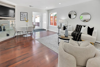Modern living room with white furniture, wooden floor, and decor elements two circle mirror