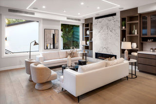 Modern living room with white sofa, armchairs, and a fireplace. cute lamp and desgin looking 