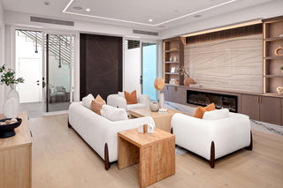 Modern living room with white sofas,  and decorative pillows wooden coffee table