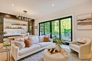 Modern living room with white sofa, armchair, and decorative items.