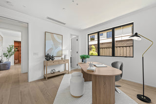Modern office space with a wooden desk, chair, and decorative items with long lapm and gorgeous design