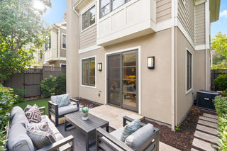 Outdoor patio area with furniture in front of a house