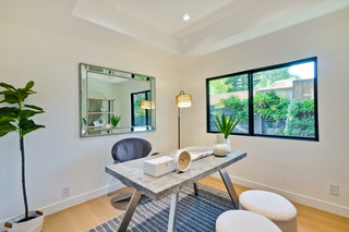 Neatly_made_bed_in_a_bedroom_with_a_large_window_and_outdoorrr_vieeww
