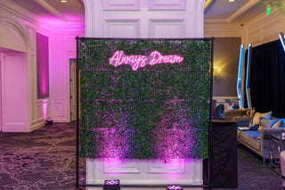 Neon sign with 'Always Dream' text in a room with decorative lighting