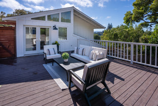 Outdoor patio area with furniture and plants on a wooden deck with beautiful outlook