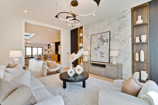 Modern living room with gray sofa, coffee table, and decorative items.