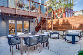 Outdoor patio area with furniture and a wooden deck.