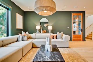 Modern living room with a sectional sofa, coffee table, and decorative items.