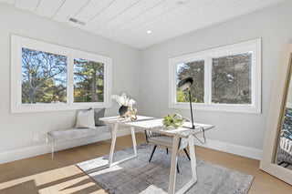 Sweet living room with white walls, large windows,