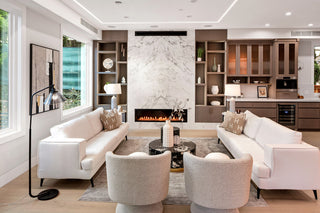 Unique living room with white sofas, marble fireplace, and wooden shelves.