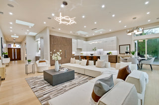 Modern living room with yellow armchair, white sofa, and decorative elements.