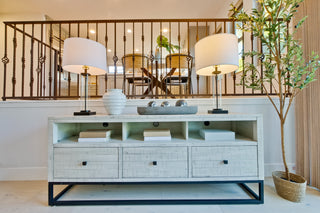 White console table with decorative items in a living room setting