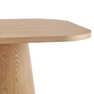 Minimalist wooden table with a light oak finish and a sleek, rounded top design.