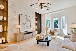present day living room with a TV, bookshelves, and decorative items.