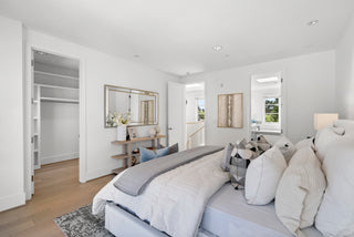 Modern bedroom with a bed, side tables, and decorative items.