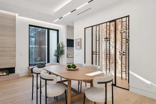 updated dining room with a wooden table and chairs, large glass doors, 